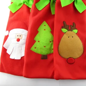 Detail view of felt Christmas wine bottle bags with Santa, tree, and reindeer patterns