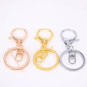 Macro view of three metal lobster clasp keychains in gold, silver, and rose gold colors