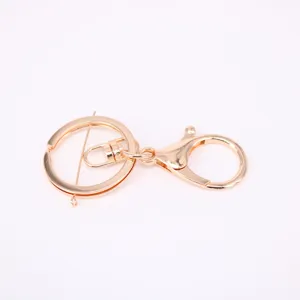 Close-up of golden lobster clasp with split key ring for DIY bag charm and accessories
