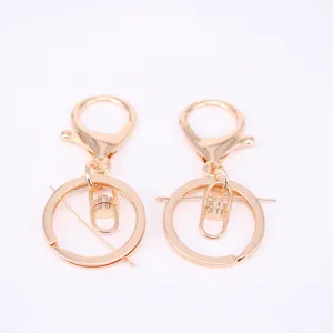 Two gold metal lobster clasps with key rings for DIY bag accessories and keychains