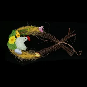 Detailed macro view of Easter nest decoration featuring a chick, blue egg and rattan twigs