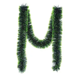 Detailed macro view of vibrant green and black Christmas tinsel garland in an M shape