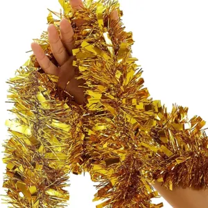 Close-up of shiny golden Christmas tinsel garland showing dense metallic texture