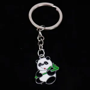 High-quality detail shot of a cute panda metal keychain with green bamboo enamel charm
