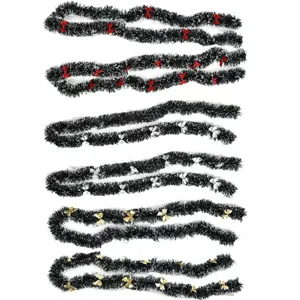 Dark green Christmas tinsel garlands with white tips and colorful bows on white background