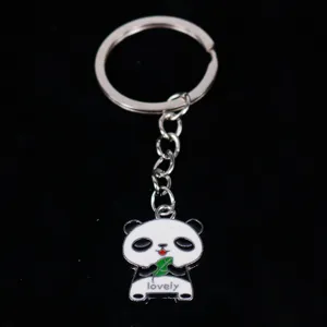 Macro view of a cute enamel panda keychain pendant with green leaf and lovely text