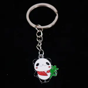 Detailed macro view of a cute enamel panda keychain featuring a green bamboo stick.