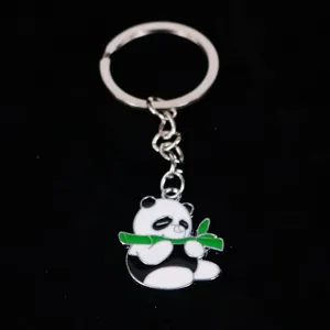 Detailed close-up of a cute cartoon panda keychain eating bamboo with silver metal ring