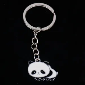 Close-up detail of a cute cartoon panda metal keychain with silver ring and chain