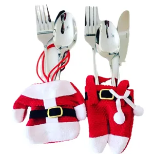 Christmas cutlery holders featuring Santa jacket and pants design for festive table decor