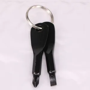 Close-up of portable black mini Phillips and flathead screwdriver tools on a keychain