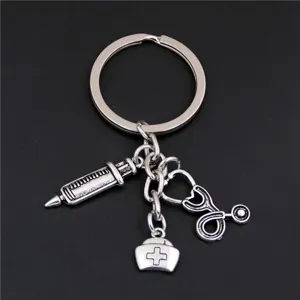 Silver medical theme keychain with syringe, nurse cap, and stethoscope charms.