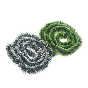 Detailed macro view showing the soft texture of green and white Christmas tinsel garlands