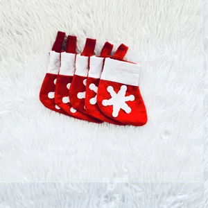 Close-up of five mini red and white Christmas snowflake stockings for cutlery sets