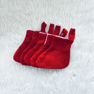 Detailed view of five mini red felt Christmas stockings for holiday cutlery holders.