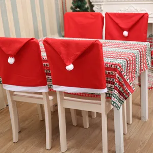 Festive Christmas dining set with four Santa hat chair covers and patterned tablecloth