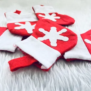 Close-up of mini red and white Christmas snowflake stocking cutlery holders on white fur