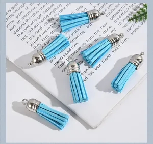 Close-up view of sky blue suede leather tassels with silver metal caps for DIY jewelry crafts