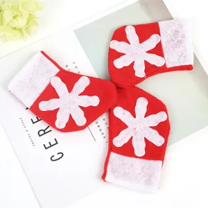 Set of three mini red Christmas snowflake stockings for festive cutlery holders
