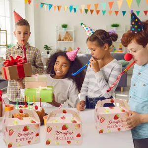 Pink strawberry gift boxes featured in a joyful and colorful children's birthday party