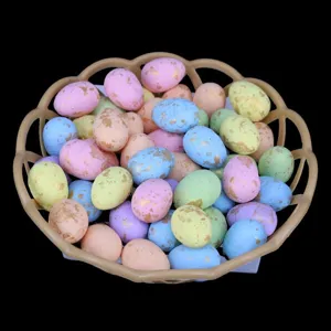 Detailed macro view of colorful gold-speckled foam Easter eggs in a brown basket