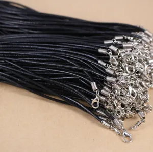 Close-up of black wax necklace cords with silver lobster clasps for DIY jewelry