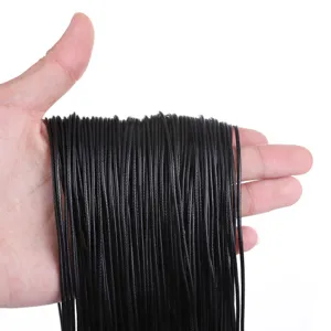 Close-up of black waxed cord necklaces held in hand for handmade DIY jewelry making