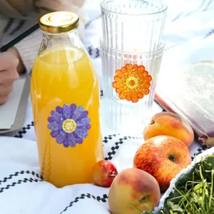 Holographic flower stickers with laser effect applied to a glass bottle in a picnic setting