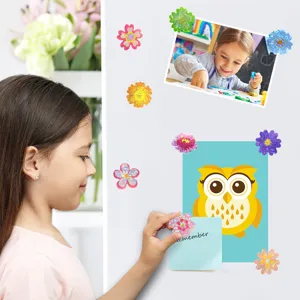 Laser flower stickers used for decorating photos and notes on a white wall