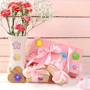 Close-up of laser colorful flower stickers applied on gift boxes and vases for DIY decor