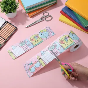 School-themed border sticker roll being cut with scissors for classroom decoration