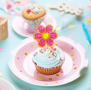 Vibrant holographic flower sticker shown as a decorative cupcake topper in a party scene
