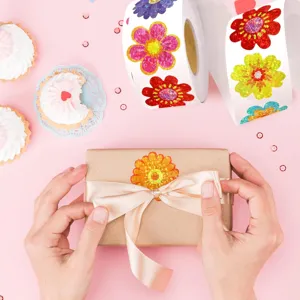 Macro view of a colorful laser holographic flower sticker applied to a gift box packaging