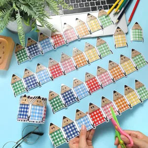 Close-up of cutting colorful pencil checkered border stickers for bulletin board decor