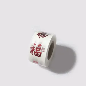Close-up macro view of a roll of festive red Fu character self-adhesive seal stickers.