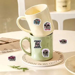 Funny cartoon hamster meme stickers applied to ceramic mugs for creative DIY decoration