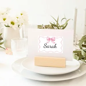 Detail view of pink bow name sticker used as a personalized place card decoration