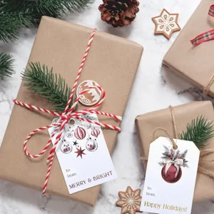 Close-up of festive Christmas gift tags on brown paper wrapped packages with pine needles