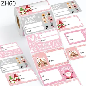 Detail van roze kerstcadeau labels op rol met kerstman en peperkoekhuisje patronen