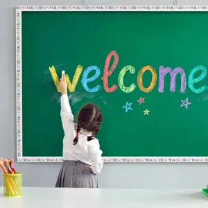 Detailed view of cartoon stationery bulletin board border stickers on a chalkboard.