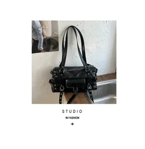 Black soft leather tote bag with punk-style eyelet straps and silver hardware detail