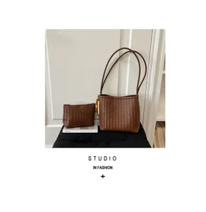 Close-up of two-piece woven brown shoulder bag and pouch set with bead detail
