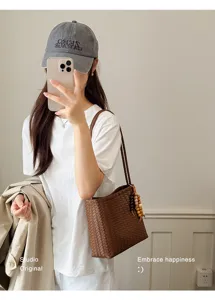 French style brown woven shoulder bag for women in a minimalist daily outfit