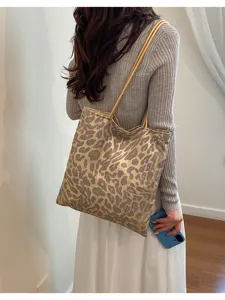 Detail shot of shimmering sequin leopard print tote bag styled on model back shoulder