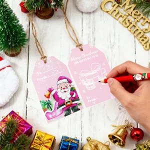 Macro detail of pink Christmas gift tags featuring Santa Claus and To/From message lines.