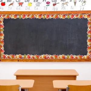 Close-up of maple leaf bulletin board border stickers on a classroom chalkboard