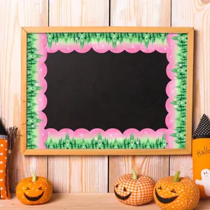 Decorative bulletin board border with pink and green castle design on a blackboard