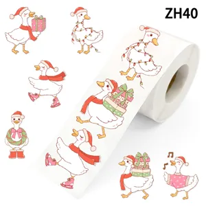 Vue détaillée d'autocollants canards blancs avec motifs de Noël festifs sur un rouleau