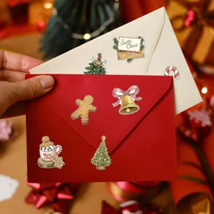 Detail view of vintage watercolor Christmas stickers sealing red and cream envelopes.