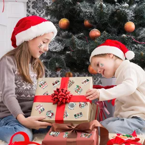 Lifestyle shot of festive Christmas stickers applied on gift boxes by children
